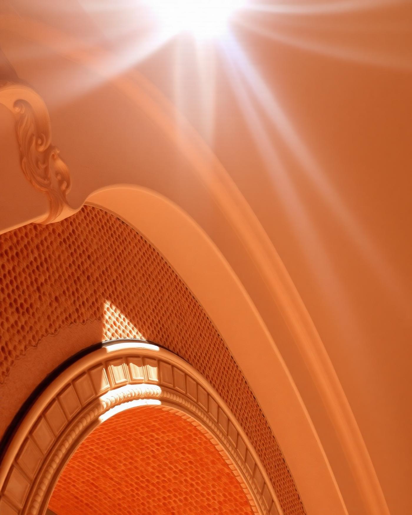 Hand-carved plaster arch detail in warm ochre